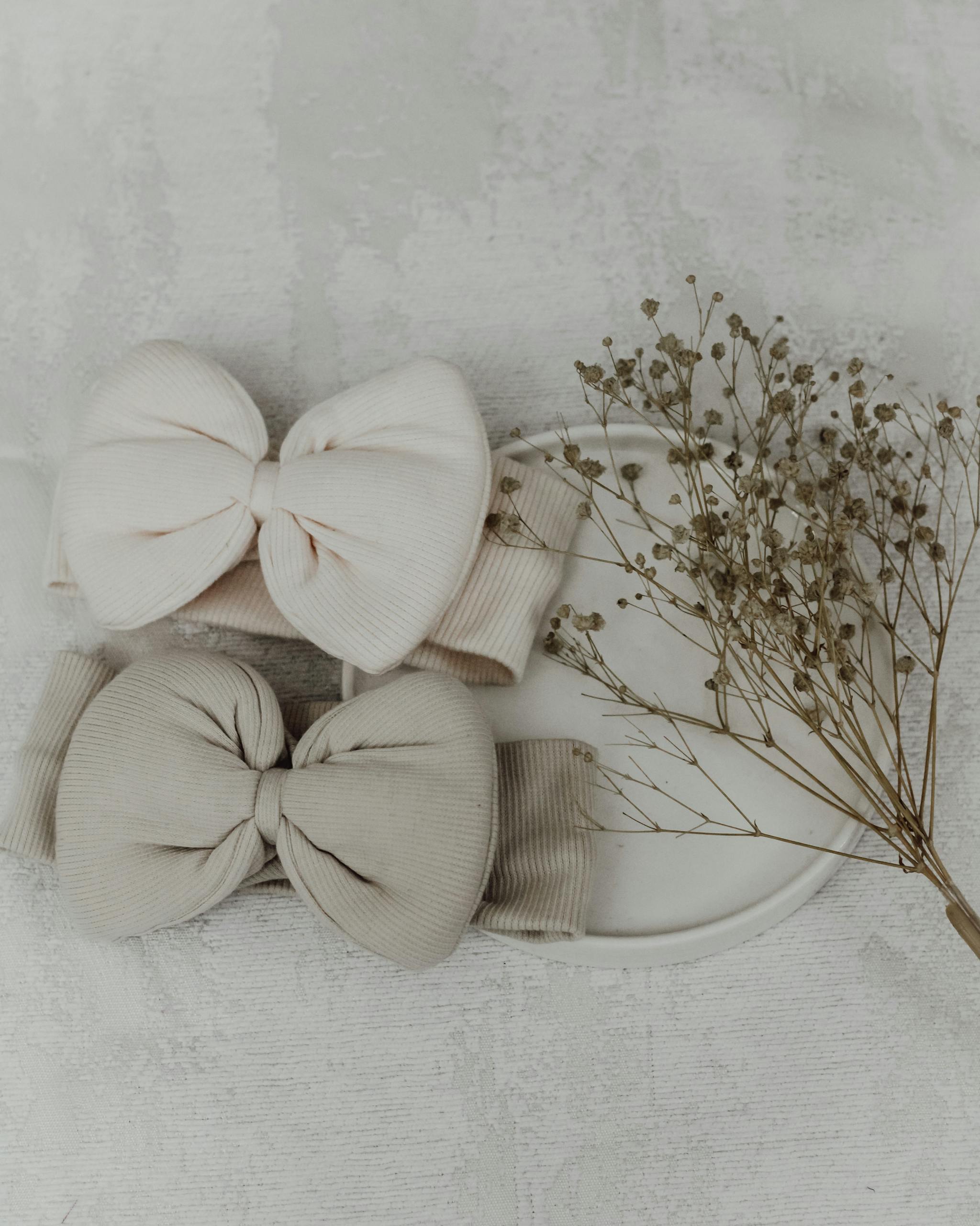 Charming baby headbands in pastel colors with bows, perfect for newborn fashion and lifestyle photography.