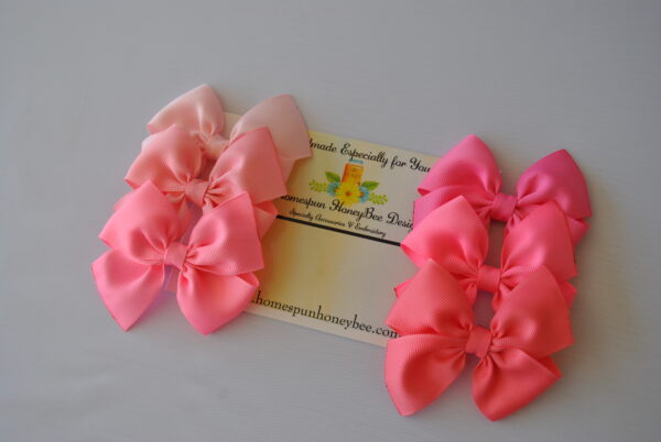a beautiful set of Shelby style hair bows in various shades of pink by homespun honeybee designs