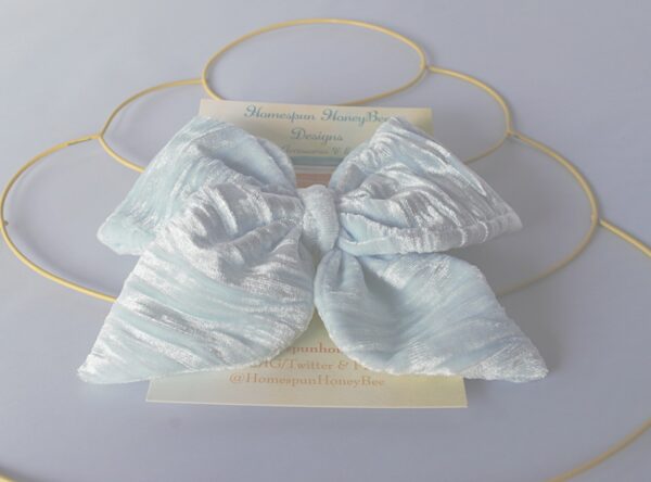 a close up view of the Alyce style bow with tails in a velvety shade of blue