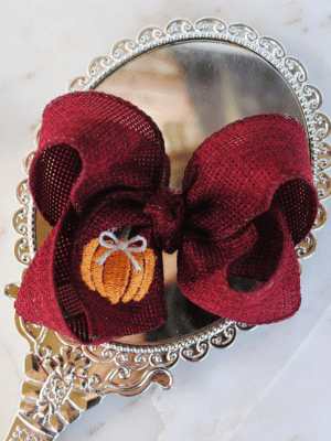 Boutique pumpkin bow made of cranberry burlap.