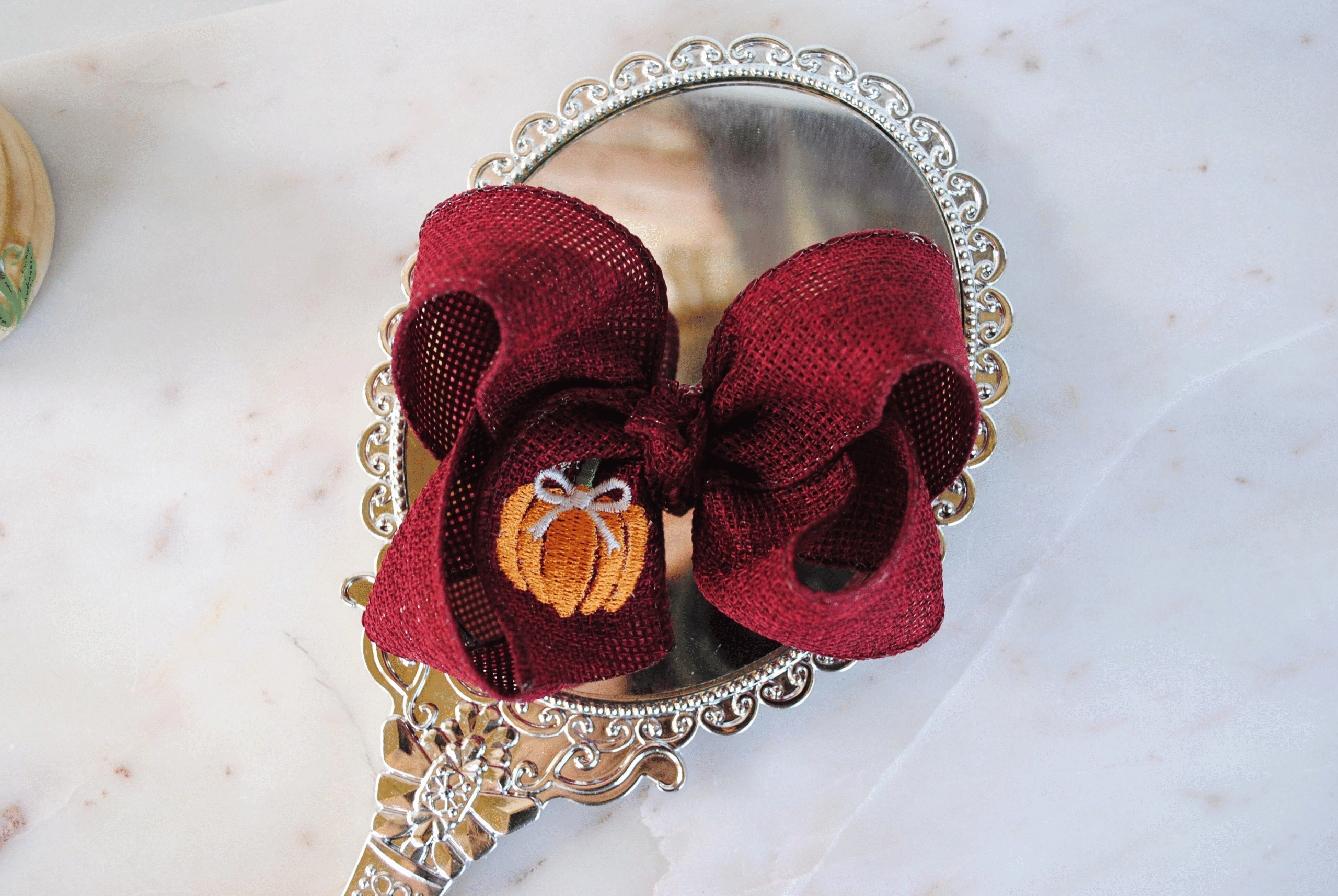 Boutique pumpkin bow made of cranberry burlap.