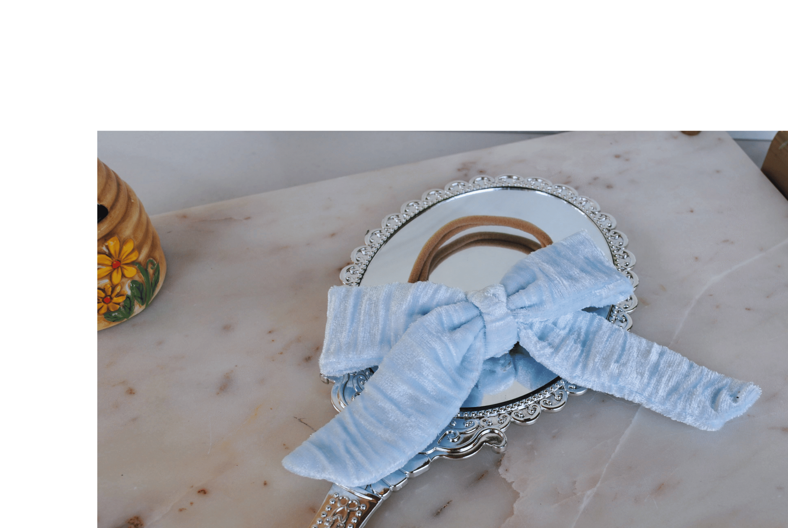 Side view of luxe baby headband in Ice Blue Velvet