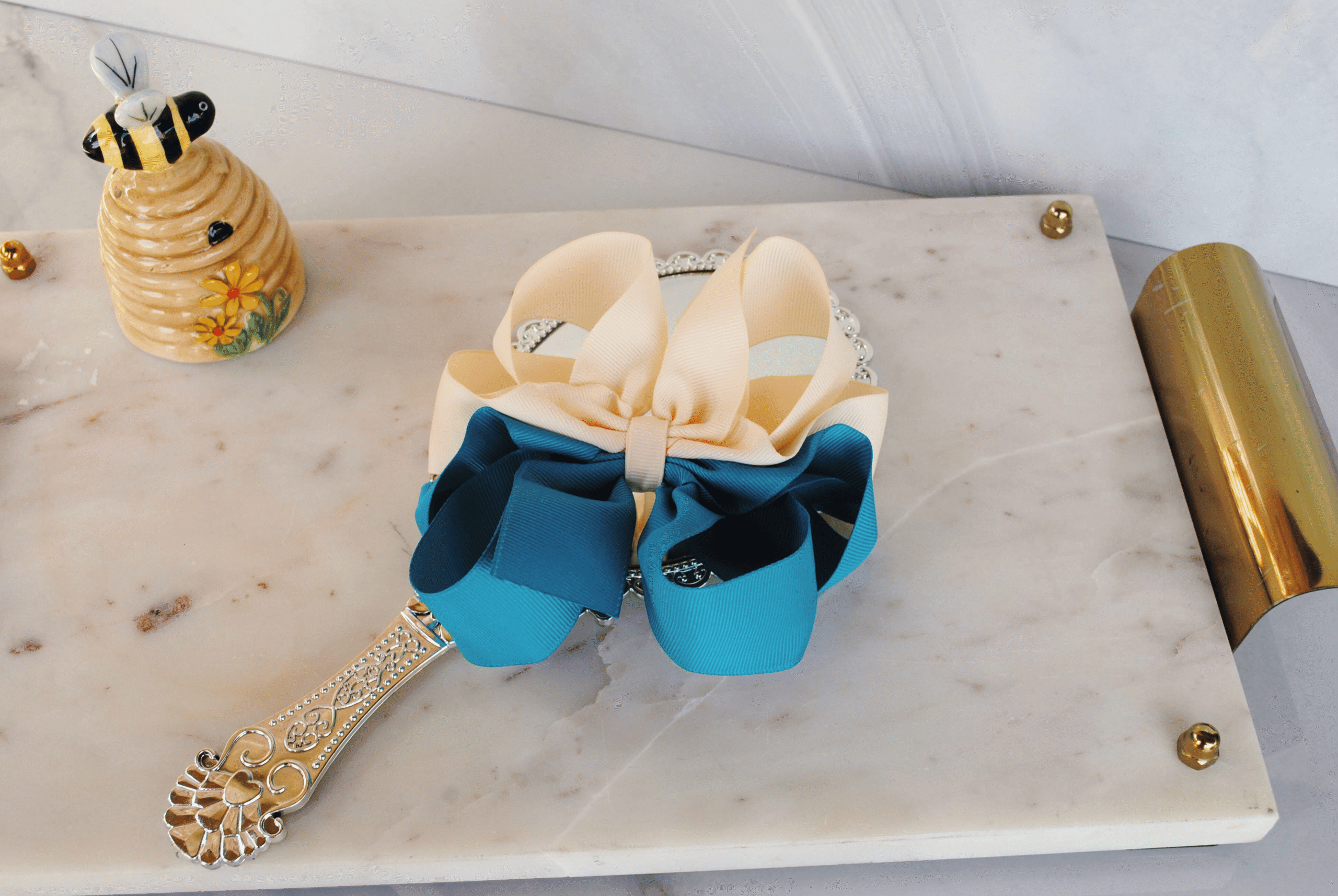 Flat view of ivory and blue ribbon bow