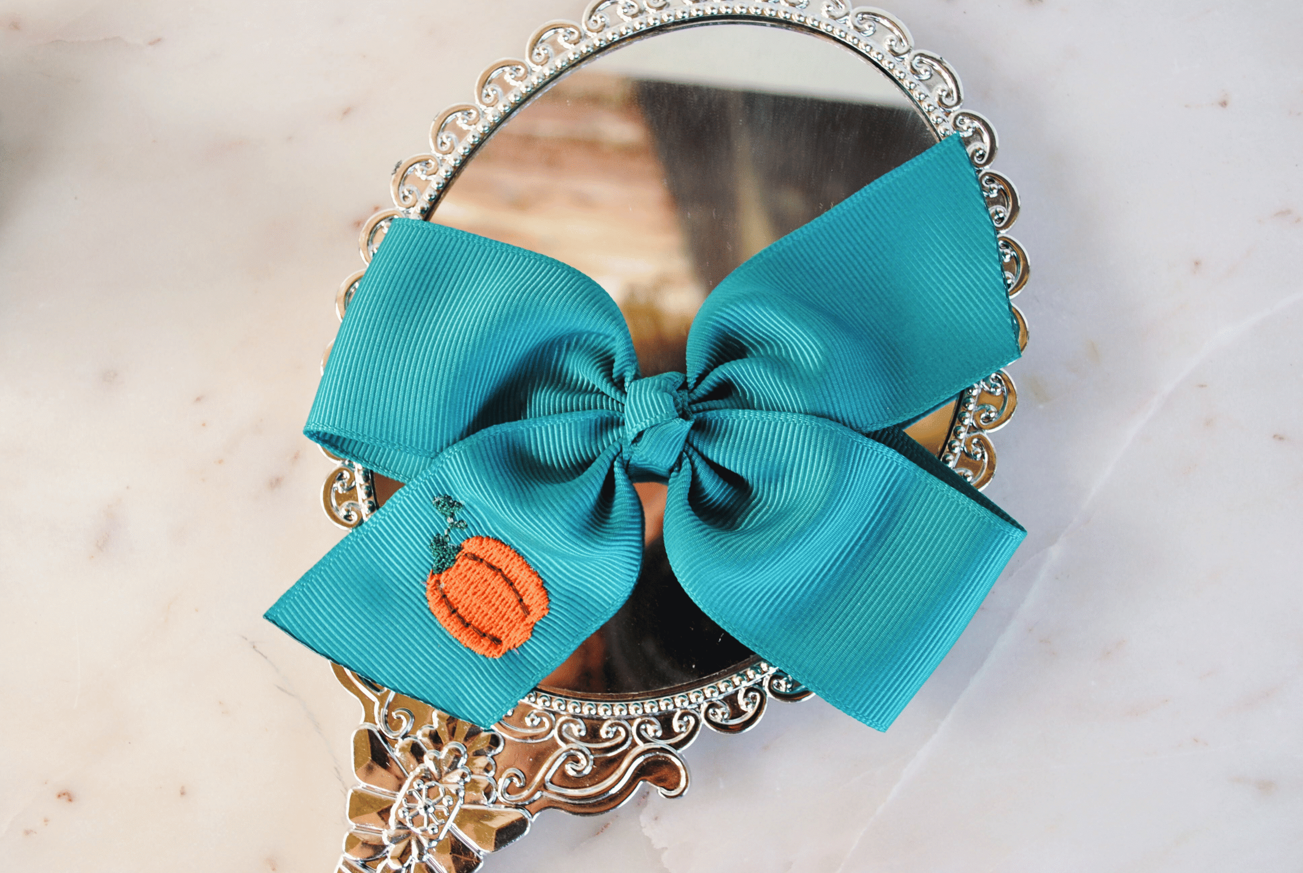 handmade large pumpkin bow on teal ribbon