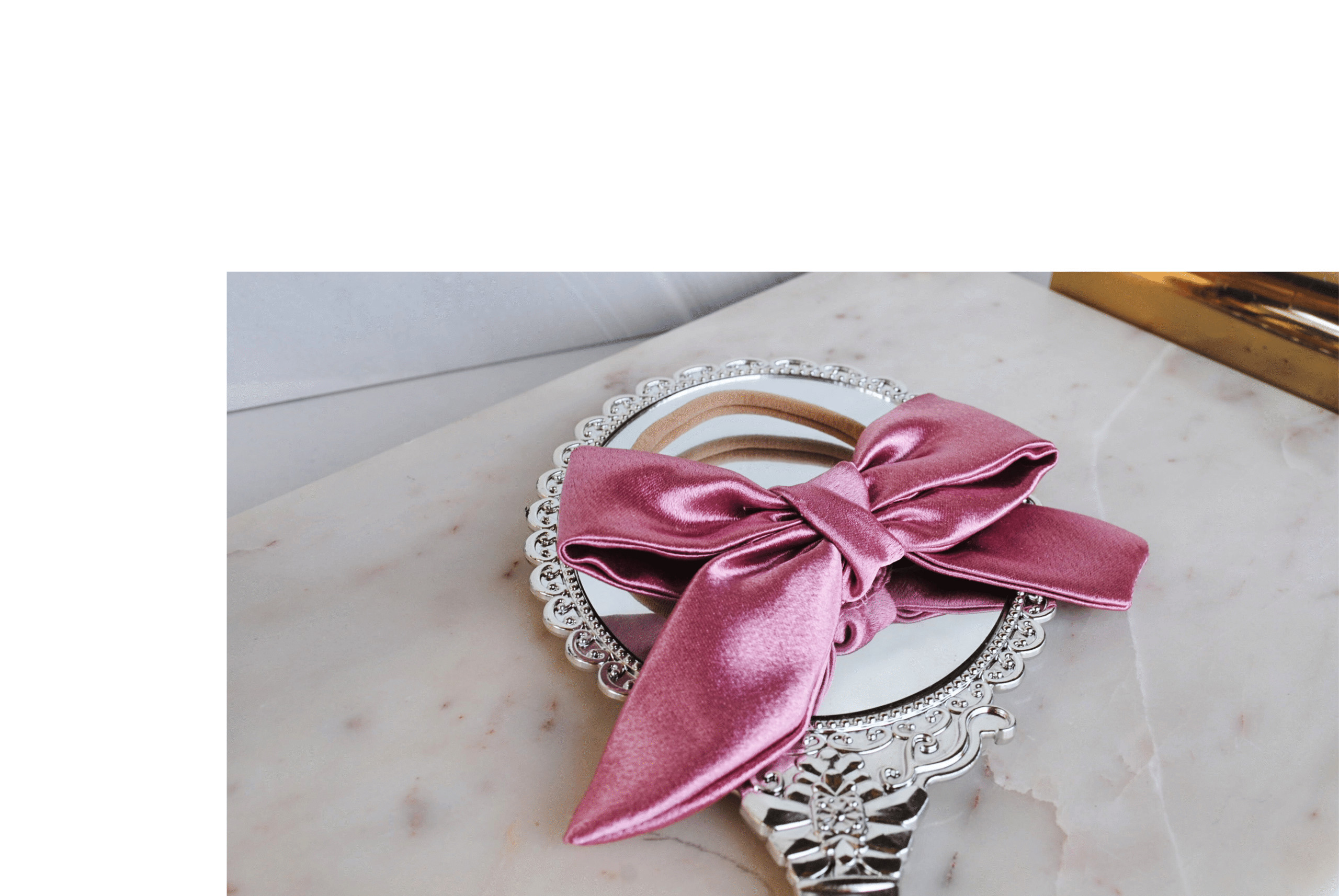 side view of rose pink satin bow on headband for baby girl