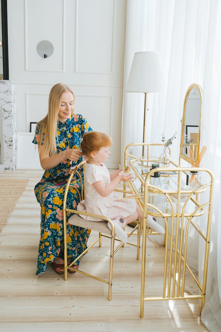 A mother and daughter bonding moment as hair is styled at a modern vanity.