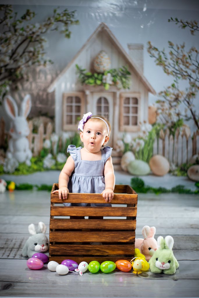 Speaking Life While You Braid: What to Say During Morning Hair Time 3 Cute baby in wooden crate surrounded by Easter decor in a spring setting.