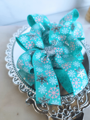 Pigtail hair bows made from Aqua blue ribbon with foil snowflakes