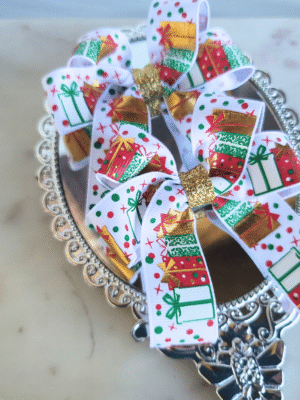 pigtail ribbon bows with red and green Christmas gifts and gold glitter center