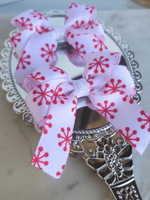 Red and white Christmas pigtail bows with snowflake accent.
