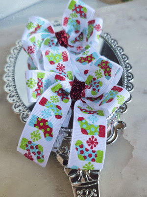 pigtail bows with Christmas ribbon featuring red and green stockings