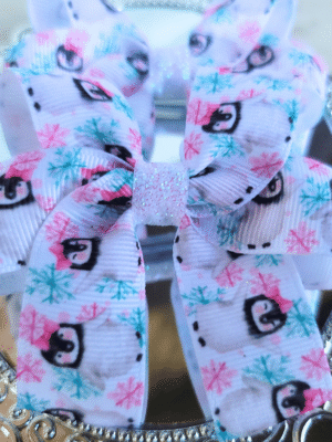 A pair of penguin pigtail bows for girls