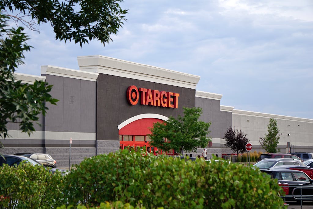 What We Lose When We Rush Girlhood: A Mother's Manifesto 2 View of a Target store with parking lot, featuring signage and greenery.